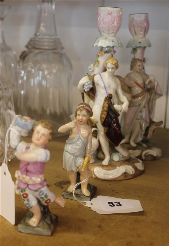 Two German figural candlesticks and two smaller figurines